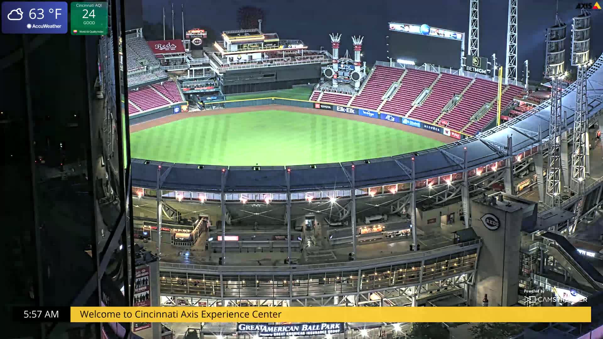 A nighttime, high-angle view of a mostly empty baseball stadium illuminated under a clear sky.