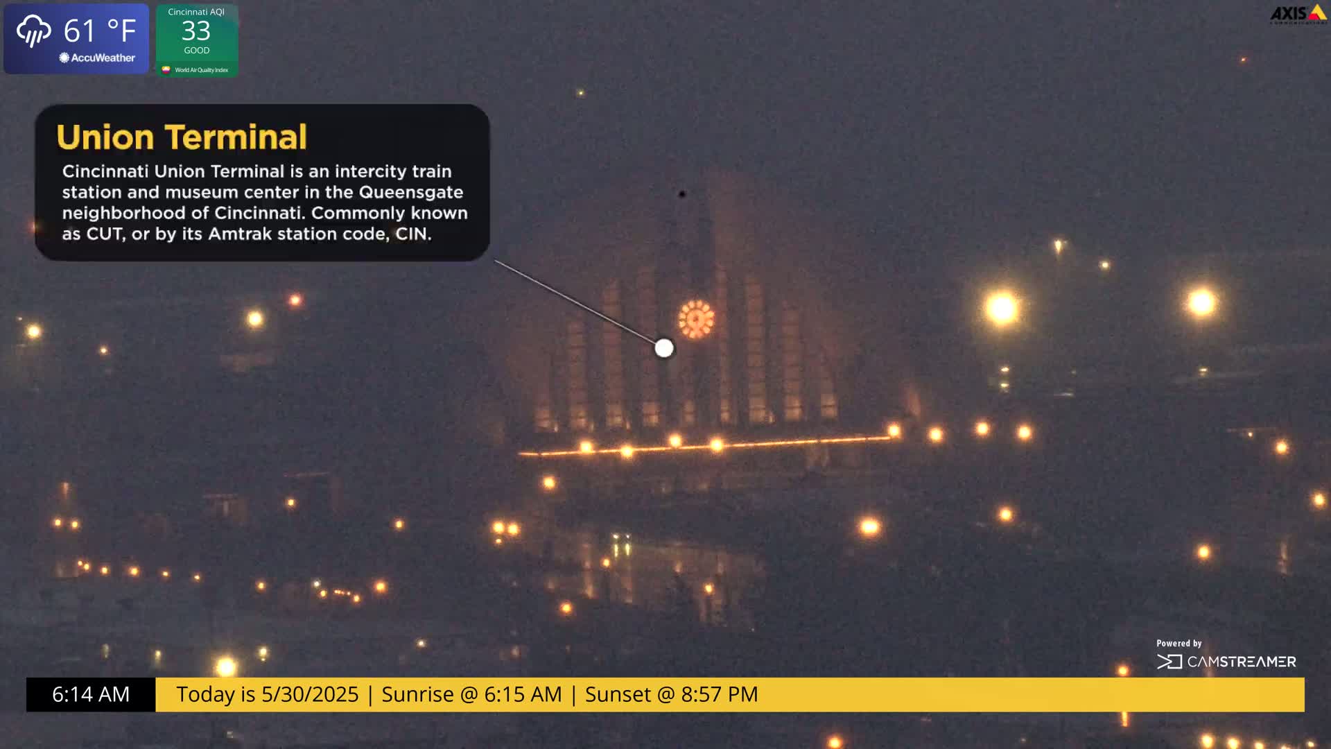 A dimly lit train station is seen at night in hazy conditions.