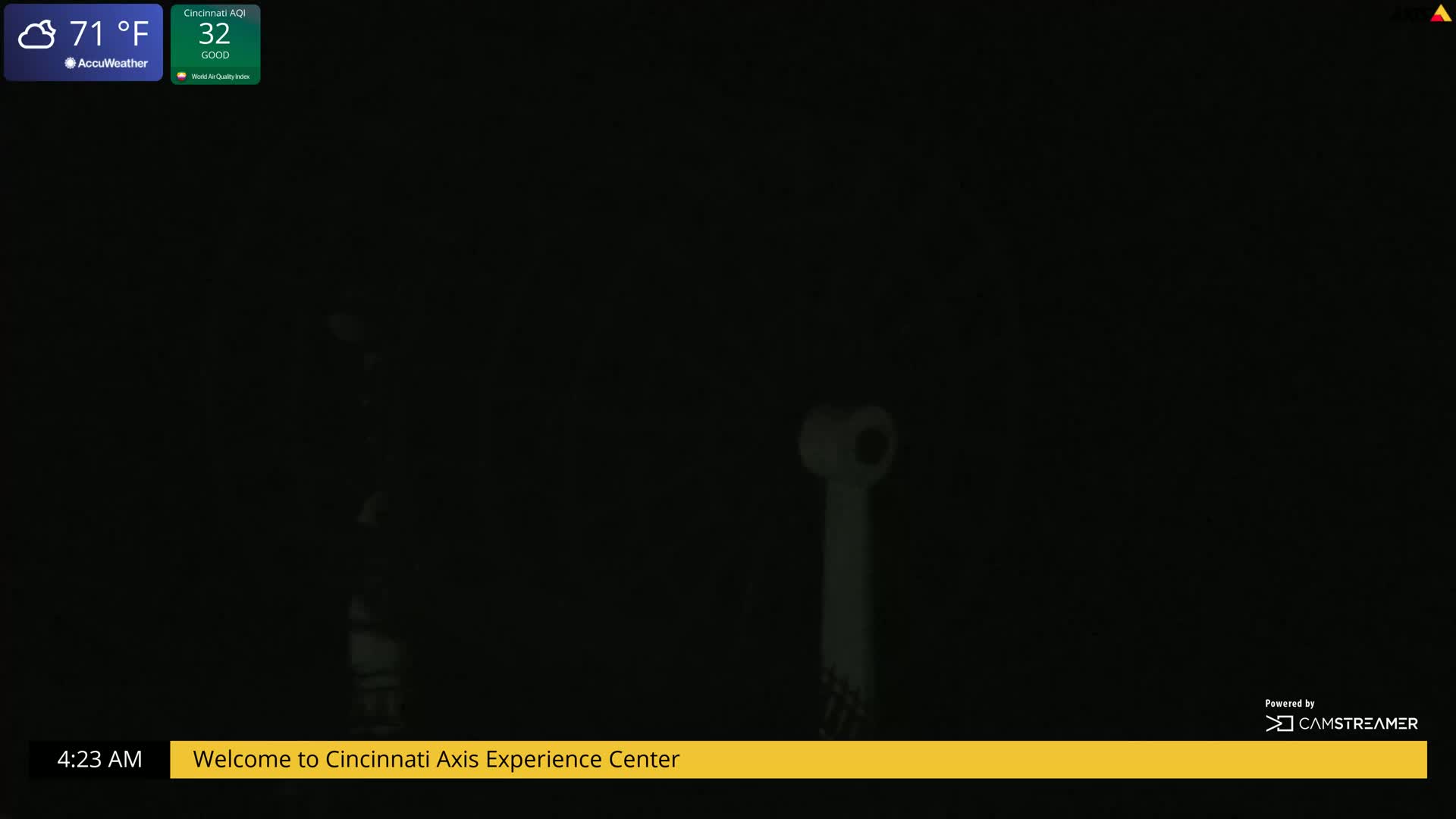 A mostly dark nighttime scene shows a faintly illuminated, tall, thin, white object.