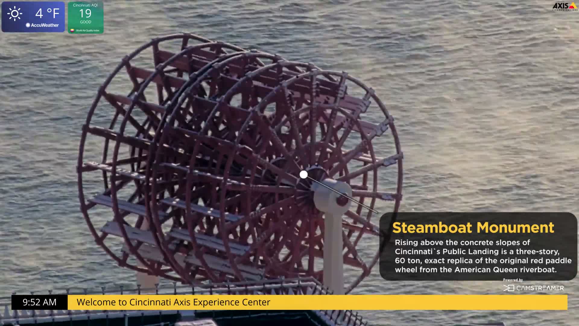 An elevated, monochrome view captures a snow-dusted baseball stadium illuminated by its internal lights on a clear, cold night.