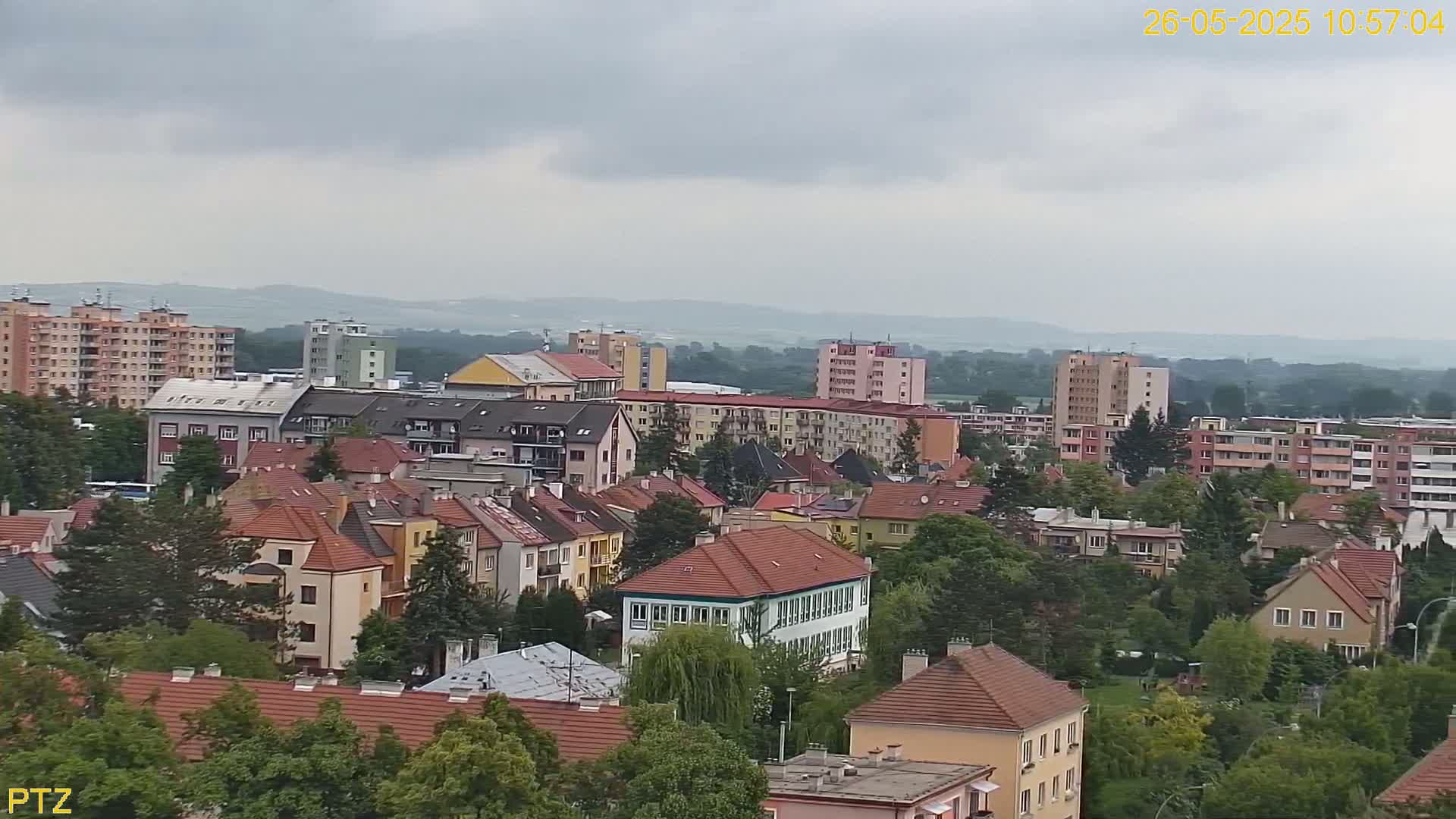 A sprawling residential area with mostly low-rise buildings under a cloudy sky.