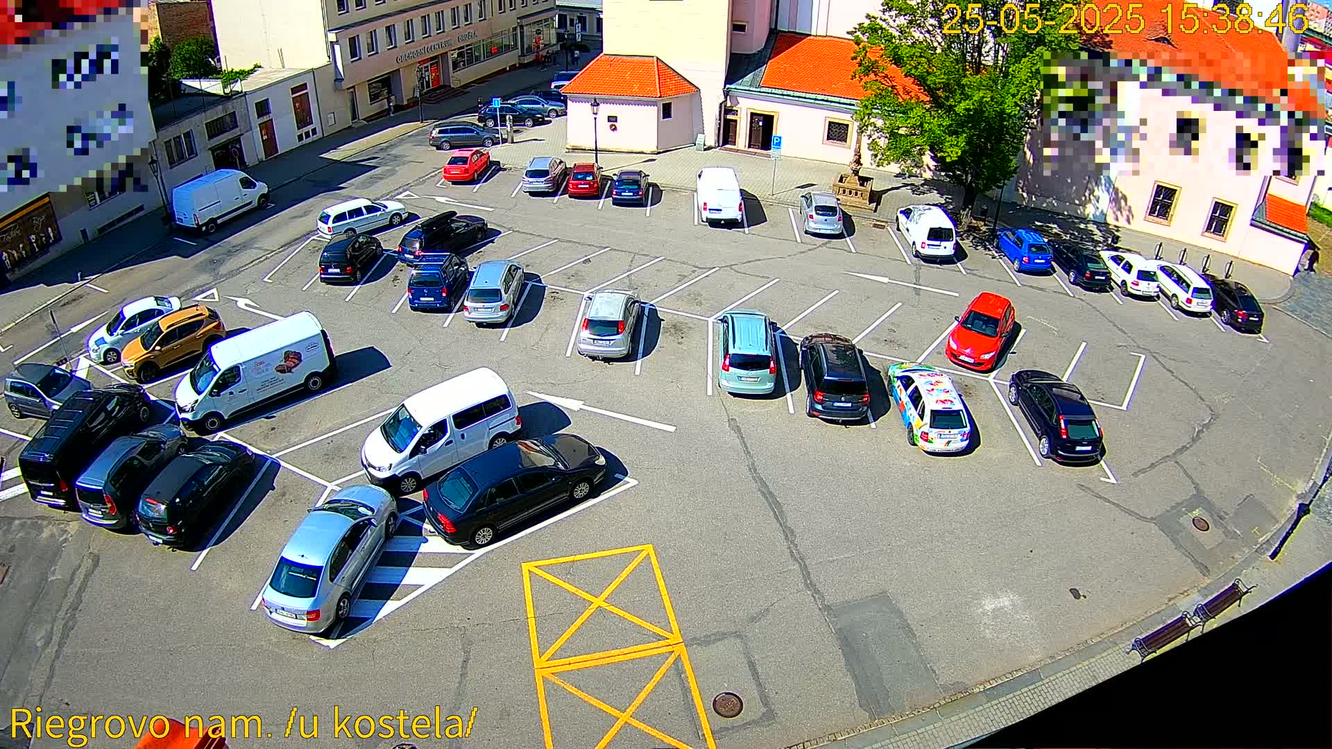 A sunny day view of a parking lot filled with cars surrounding a church.