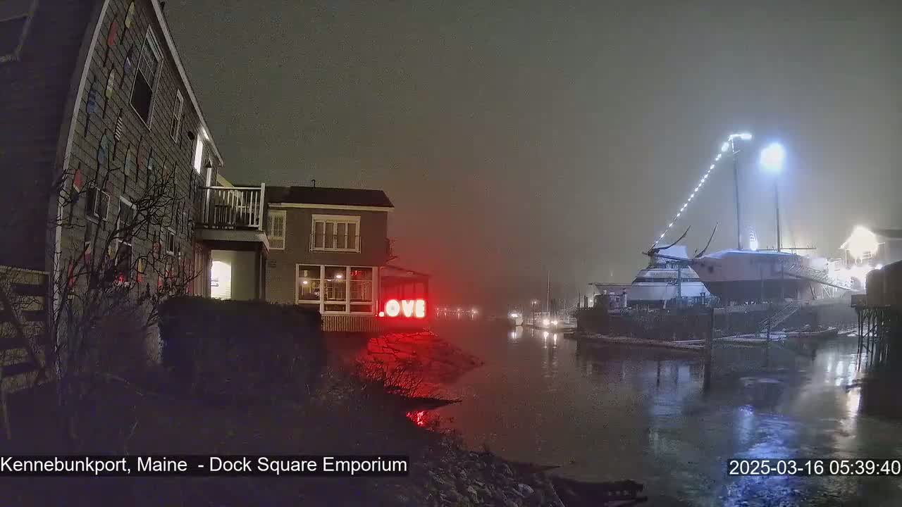 A foggy nighttime scene shows a waterfront with buildings, a large boat, and illuminated red "LOVE" letters on a building.