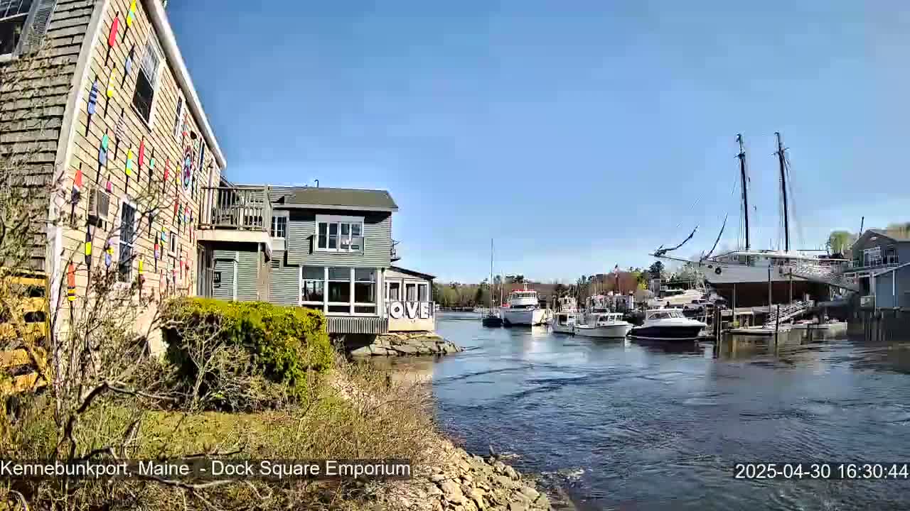 A colorful building with boats docked in a calm waterway under a clear blue sky.