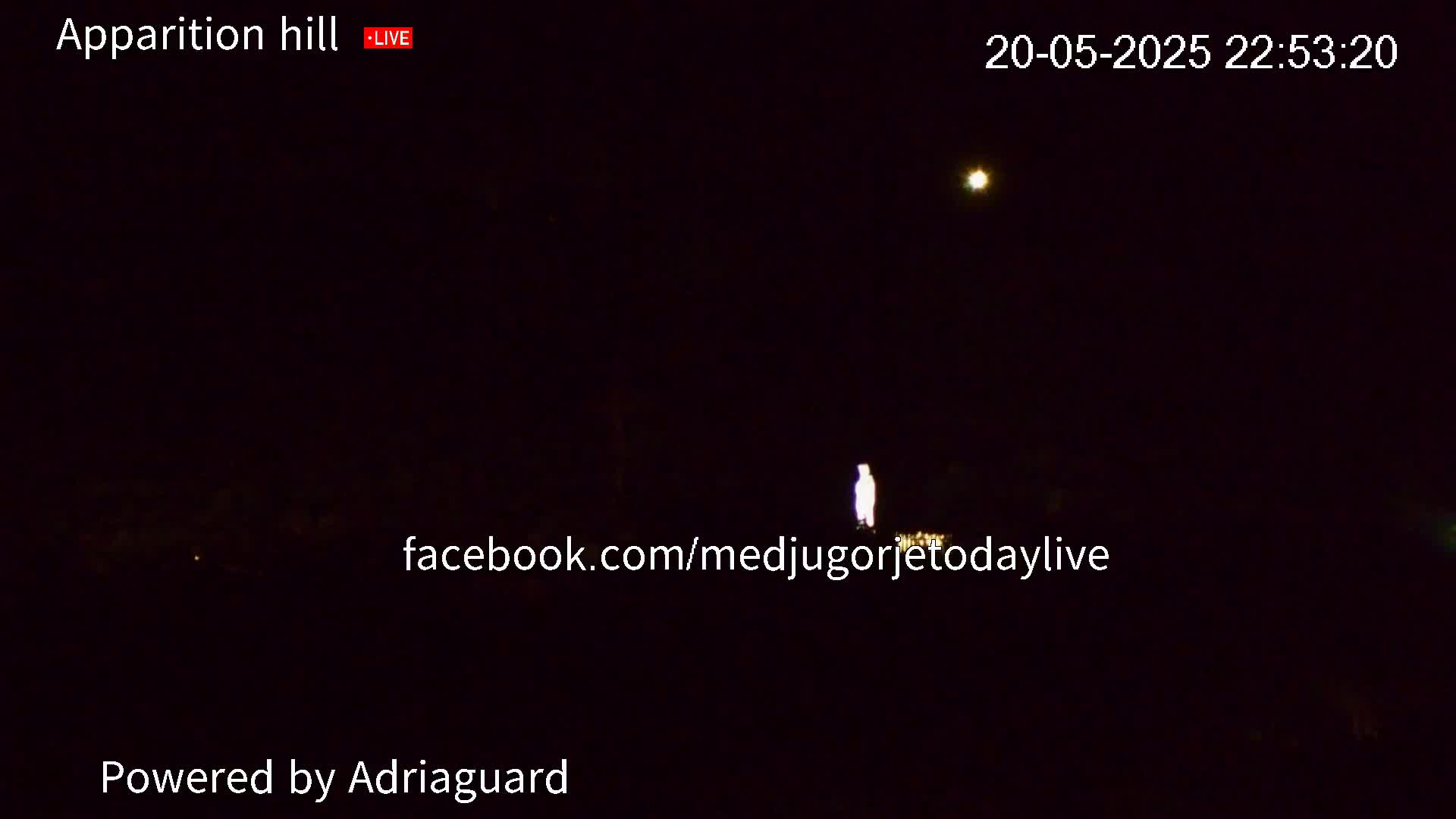 A dimly lit figure stands in a dark, outdoor scene at night under a clear sky with a bright star visible.
