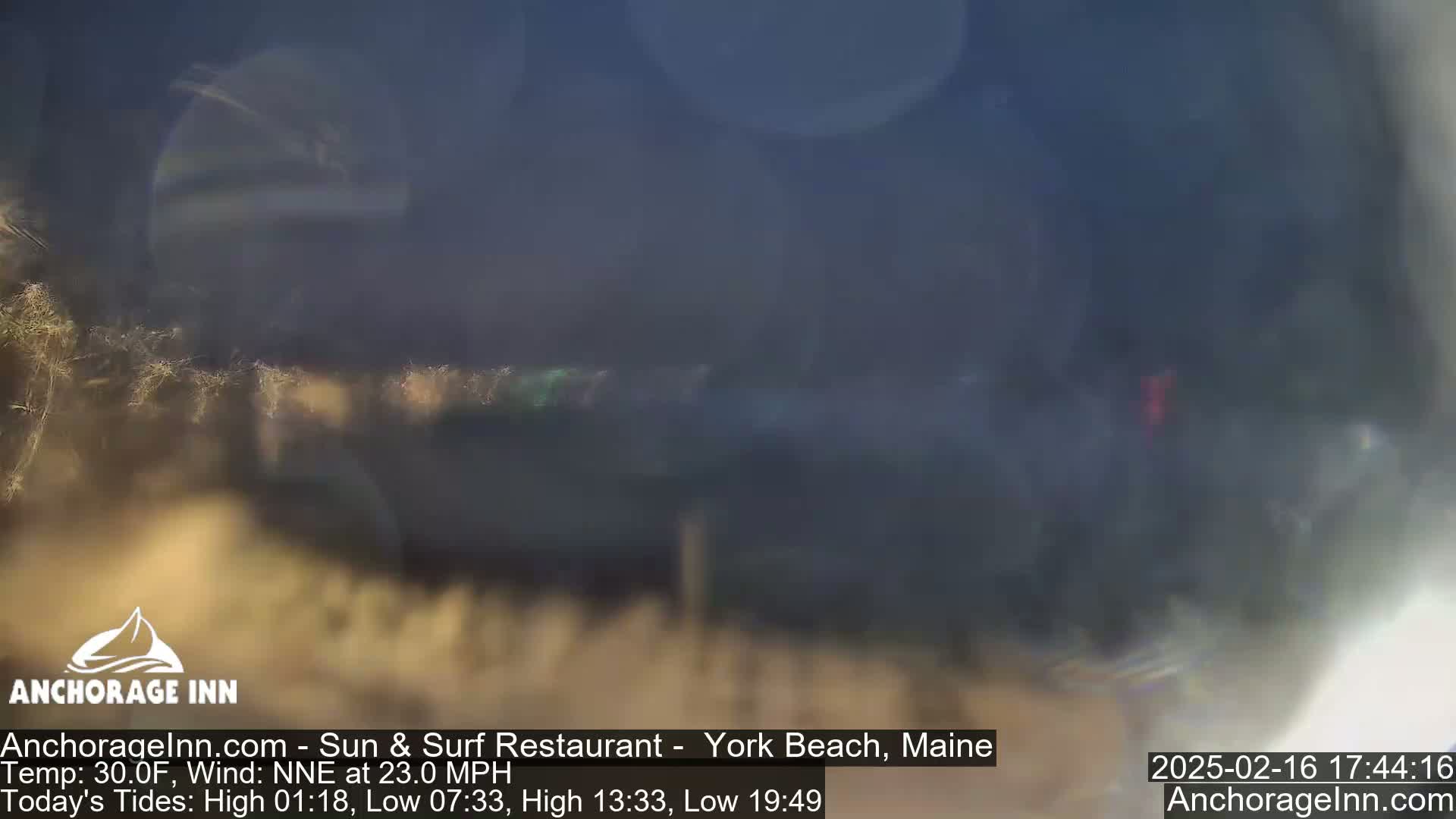 A blurry, out-of-focus view of a beach scene on a cold, windy day.