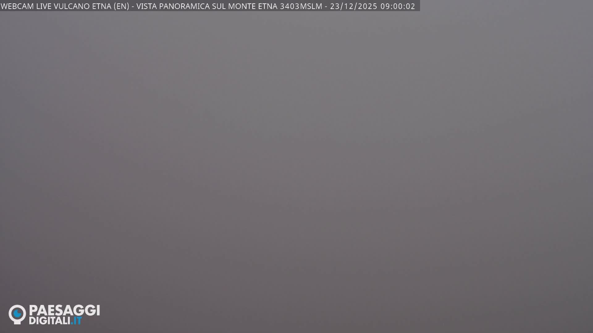 The image displays a completely obscured outdoor view, appearing as a uniform grey-brown color, likely due to very dense fog or clouds.