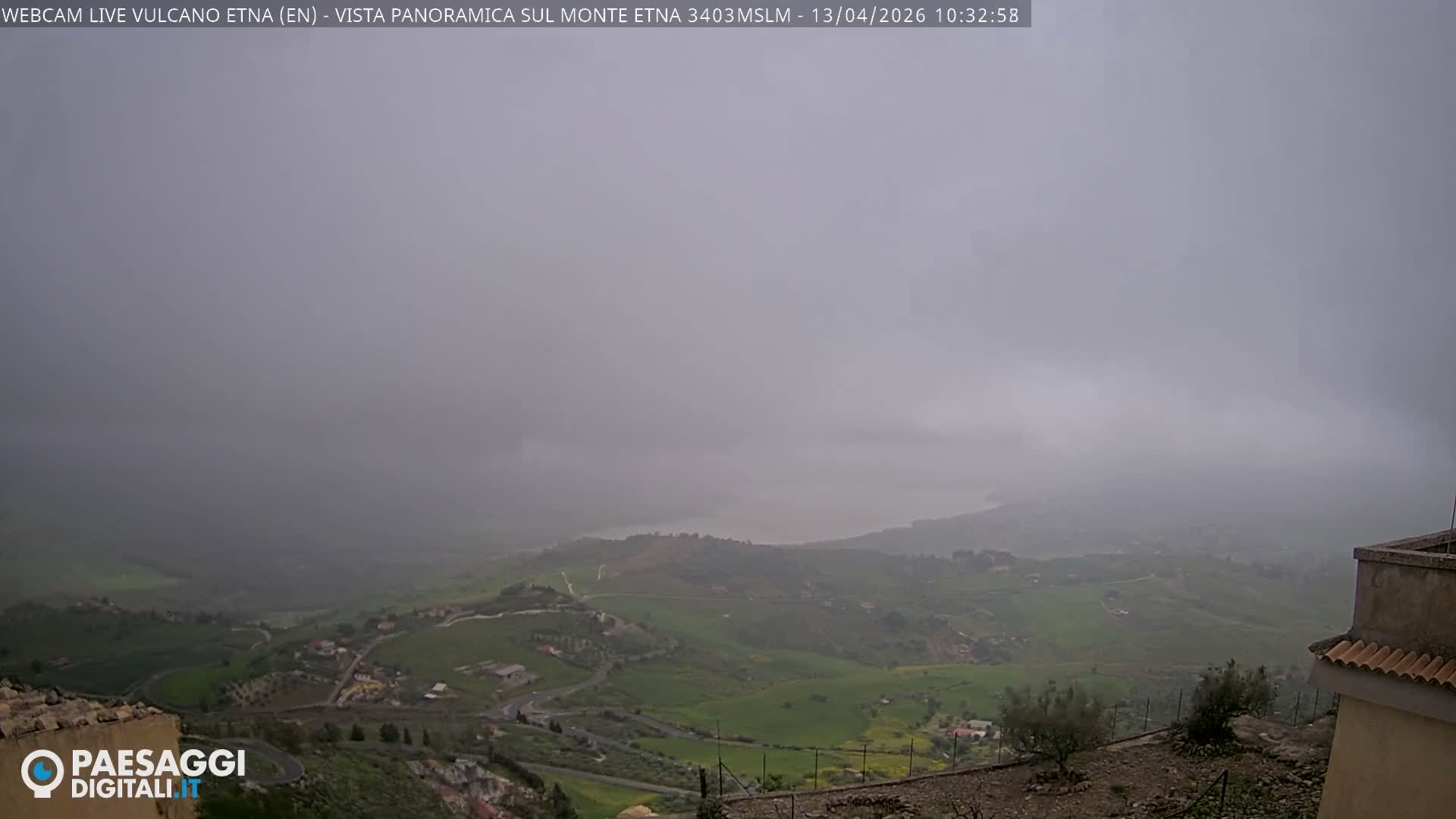 The image displays a completely obscured outdoor view, appearing as a uniform grey-brown color, likely due to very dense fog or clouds.