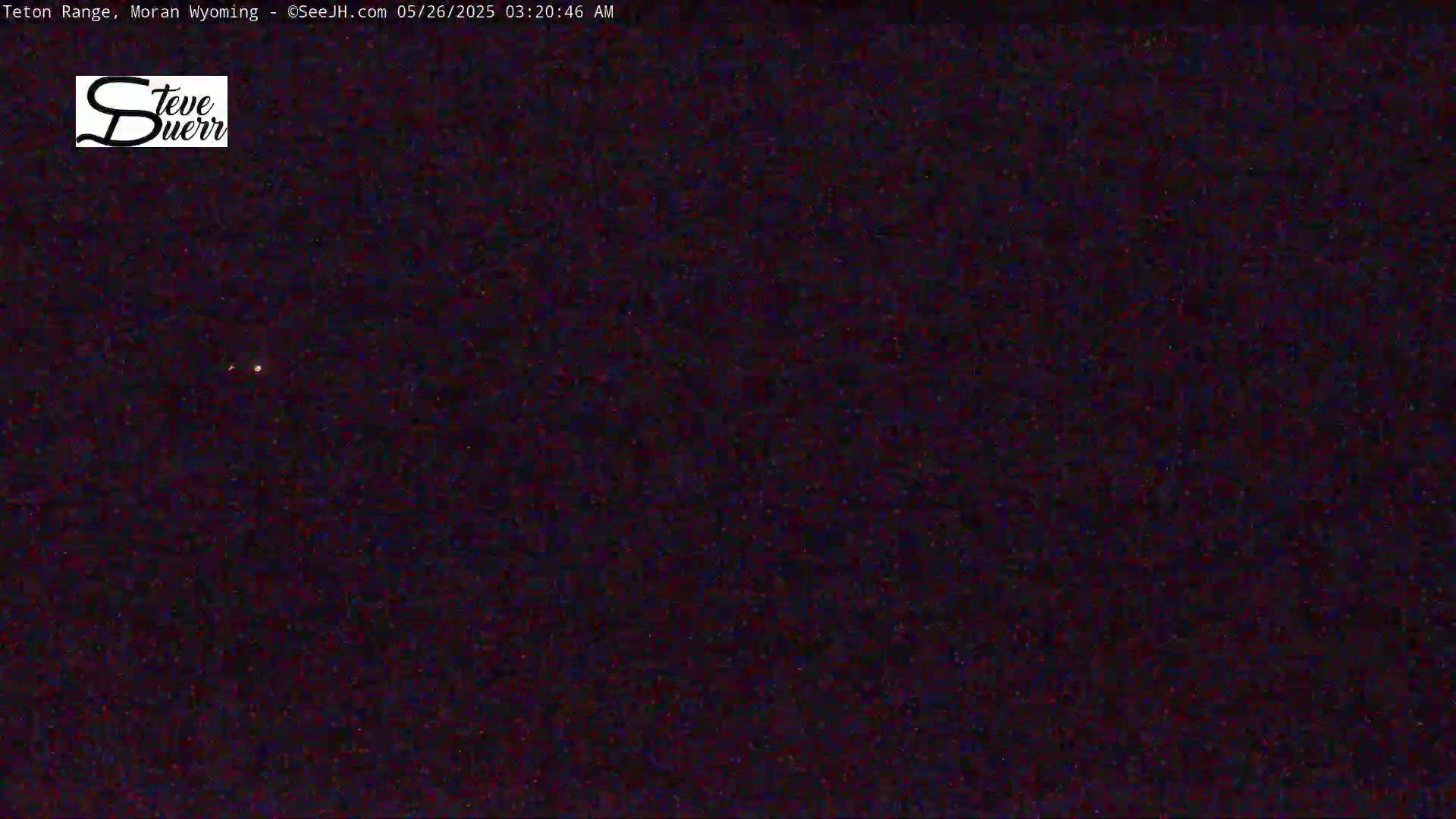 A nighttime, dark image shows a few faint stars visible in the sky.