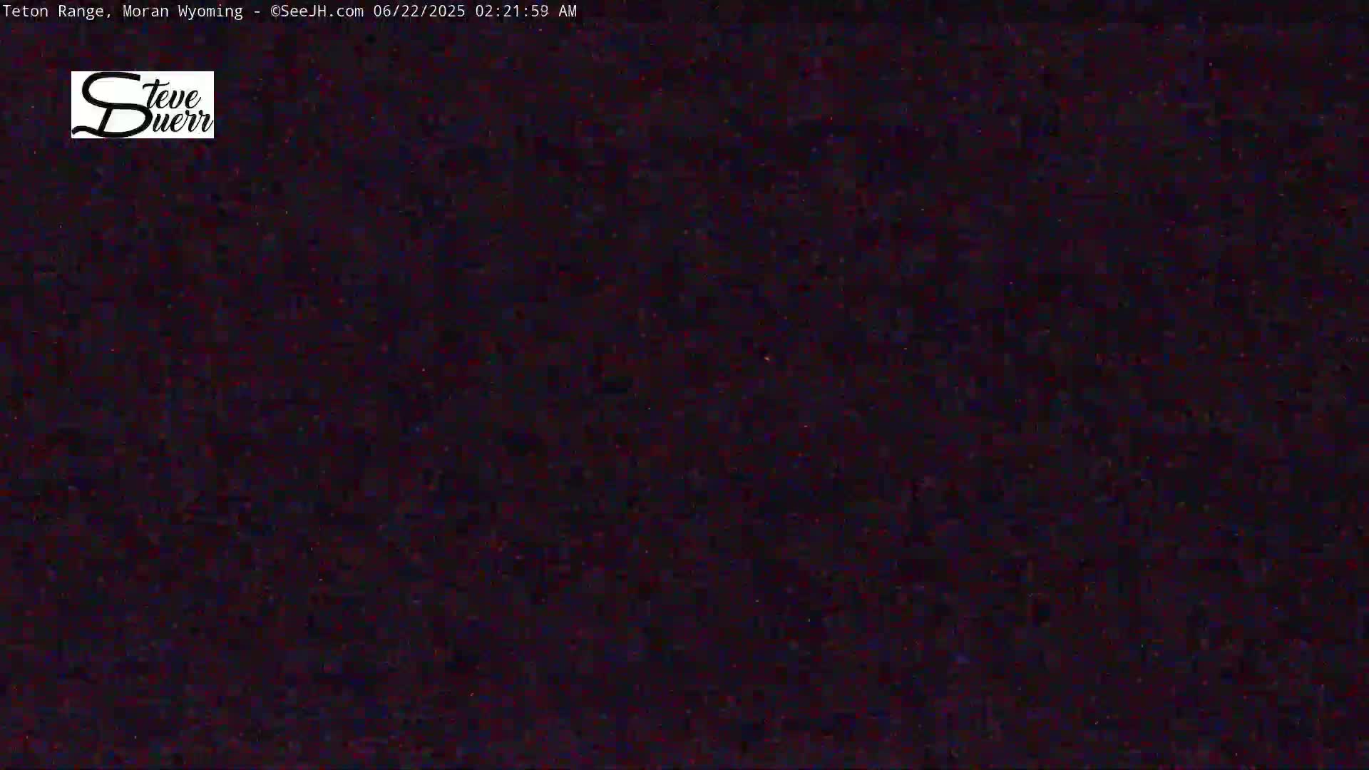 The image shows a dark, nighttime scene with a grainy, low-light texture.