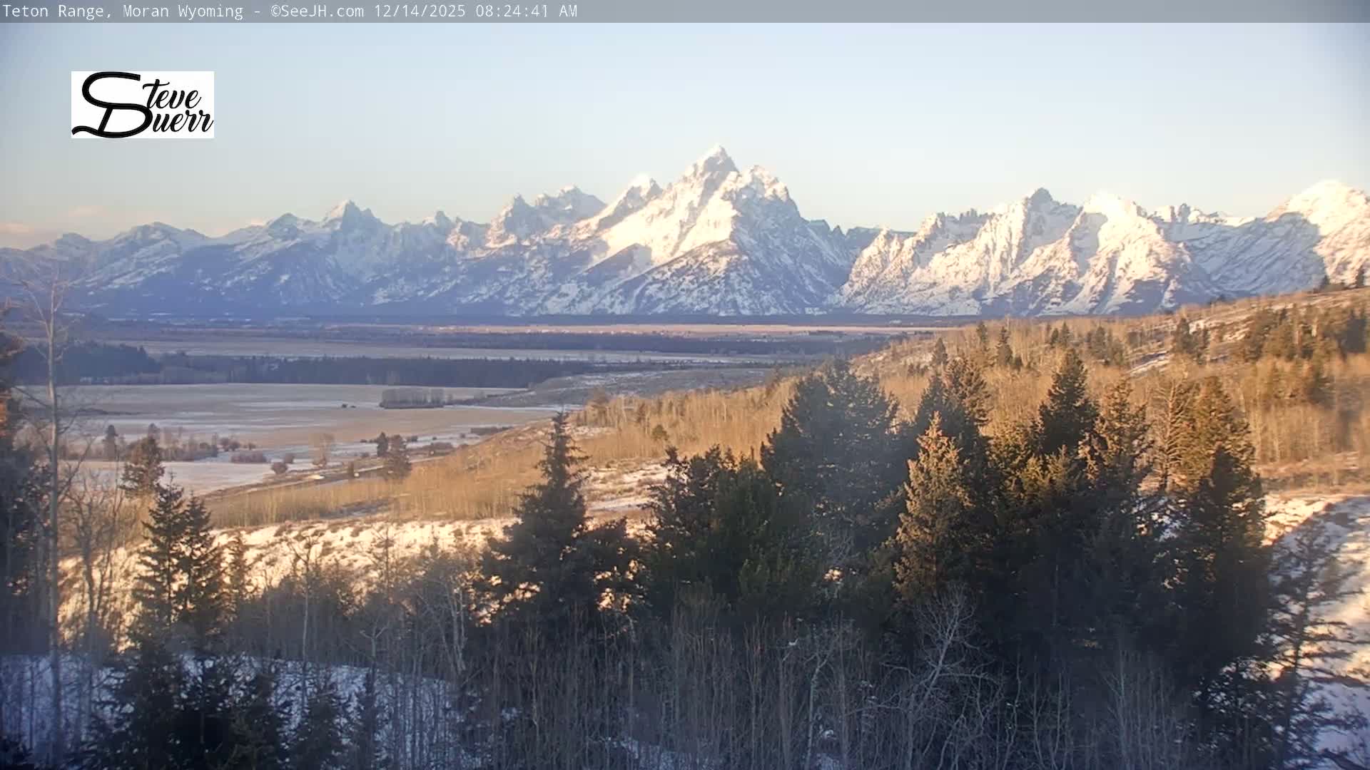 A dark and very grainy nighttime landscape is visible, showing a faint, hazy horizon with indistinct land features under a cloudy sky, and a vast, dark foreground.