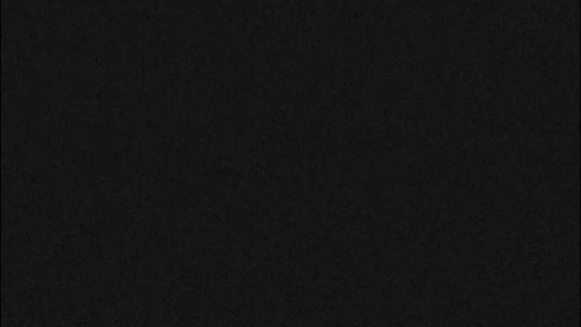 The image displays a uniform, very dark gray to black textured surface, making it impossible to discern any specific objects, scene, or outdoor weather conditions.