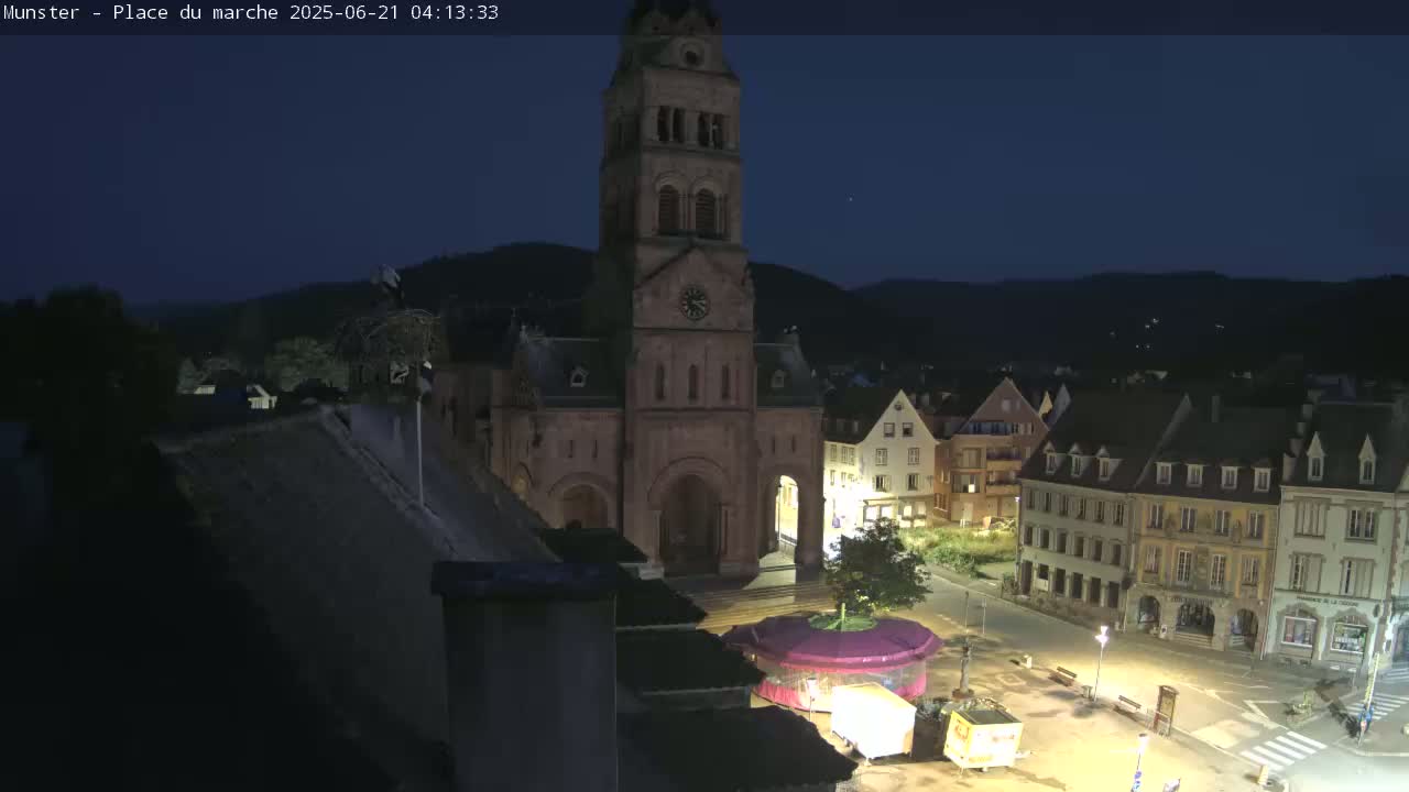 Munster,Place du Marché ( Market Square) & La Fontaine Lion Fountain / Église protestante (Protestant Church) Live Cam -  Colmar-Ribeauvillé, Haut-Rhin, Grand Est, France