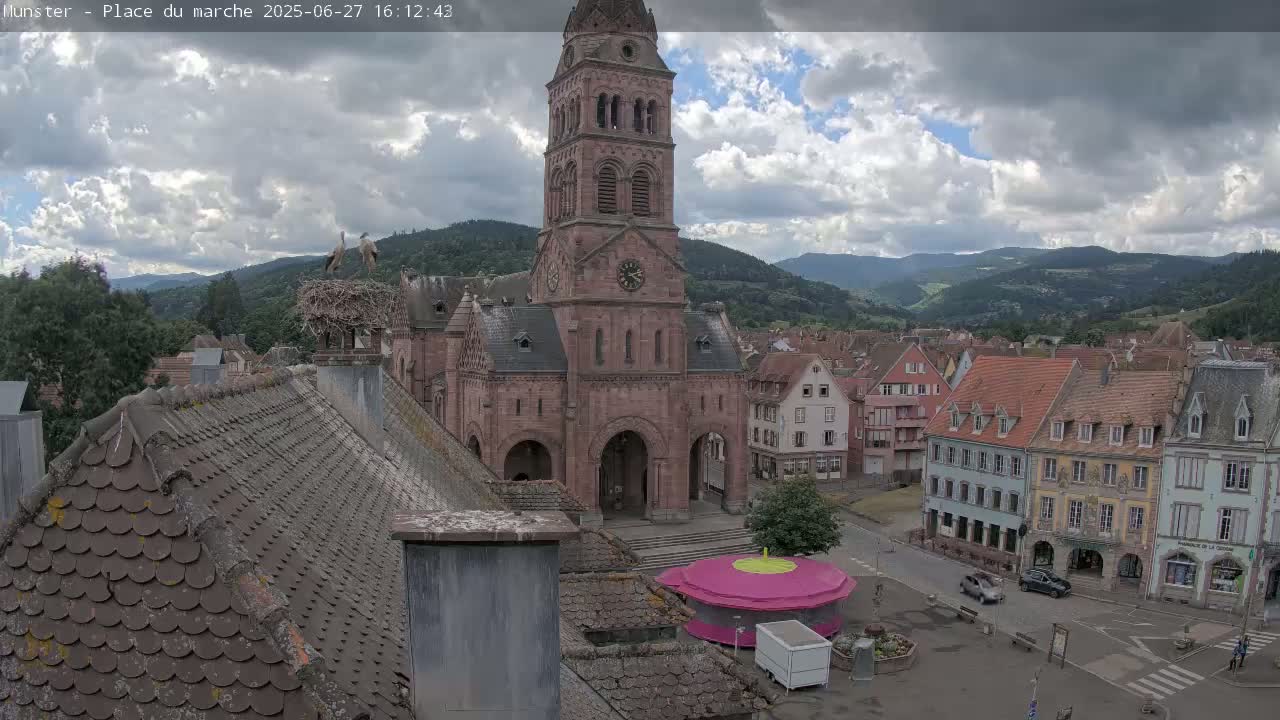 Munster,Place du Marché ( Market Square) & La Fontaine Lion Fountain / Église protestante (Protestant Church) Live Cam -  Colmar-Ribeauvillé, Haut-Rhin, Grand Est, France