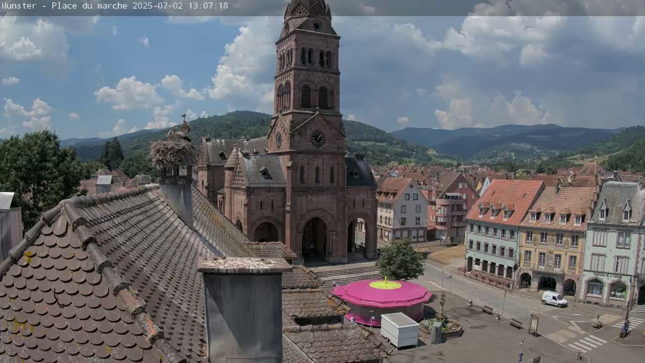Munster,Place du Marché ( Market Square) & La Fontaine Lion Fountain / Église protestante (Protestant Church) Live Cam -  Colmar-Ribeauvillé, Haut-Rhin, Grand Est, France