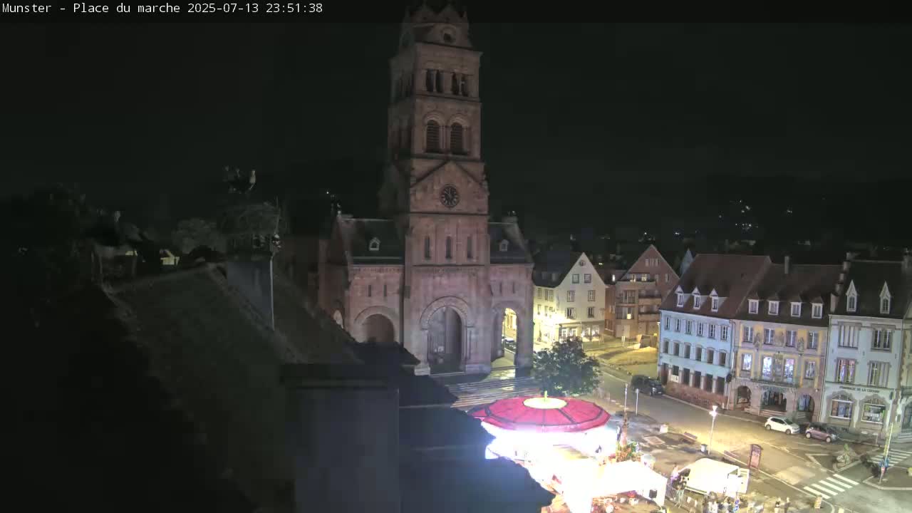 Munster,Place du Marché ( Market Square) & La Fontaine Lion Fountain / Église protestante (Protestant Church) Live Cam -  Colmar-Ribeauvillé, Haut-Rhin, Grand Est, France