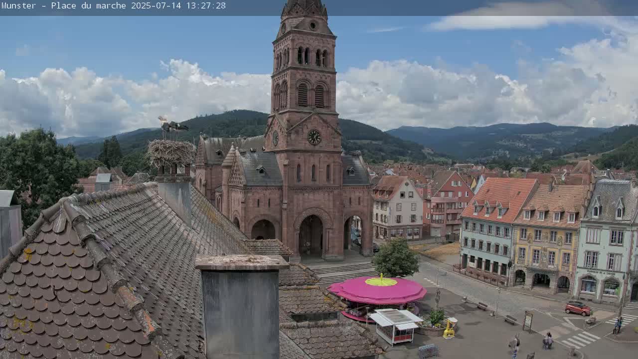 Munster,Place du Marché ( Market Square) & La Fontaine Lion Fountain / Église protestante (Protestant Church) Live Cam -  Colmar-Ribeauvillé, Haut-Rhin, Grand Est, France
