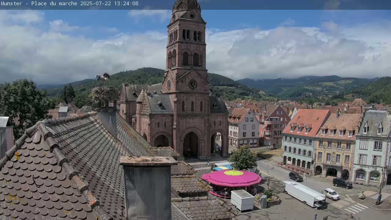 Munster,Place du Marché ( Market Square) & La Fontaine Lion Fountain / Église protestante (Protestant Church) Live Cam -  Colmar-Ribeauvillé, Haut-Rhin, Grand Est, France