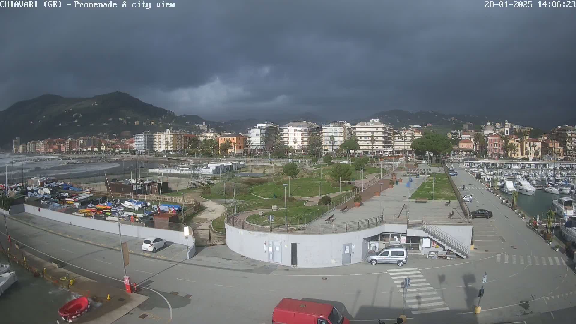A coastal city with a marina and promenade is shown under a dark, cloudy sky, with choppy waves visible in the ocean.