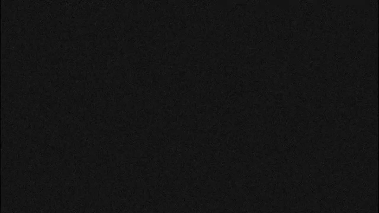 The image is completely black with a subtle, fine-grained texture.