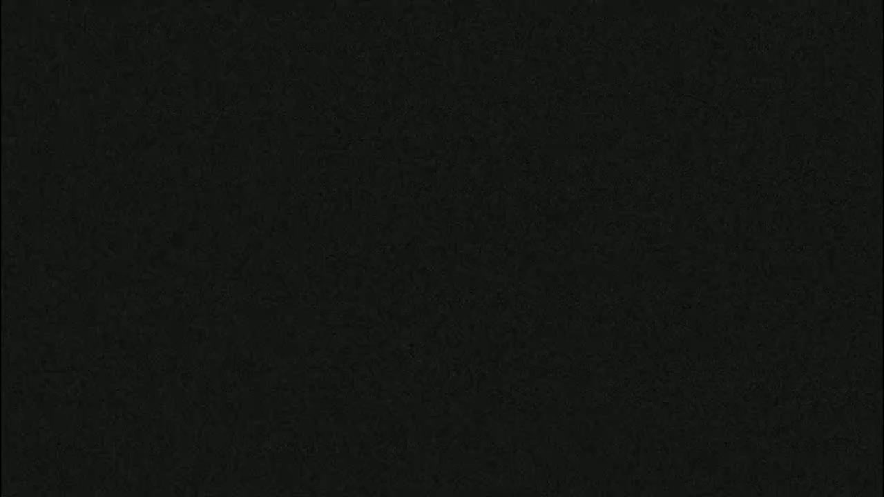 The image shows a dark gray or black textured surface.