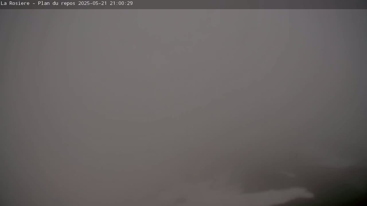 A very foggy or hazy outdoor scene is visible, with indistinct shapes suggesting a landscape barely perceivable in the low visibility.