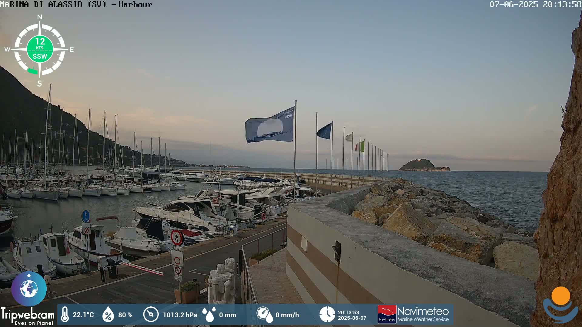 A harbor filled with boats at dusk, under a mostly clear sky.