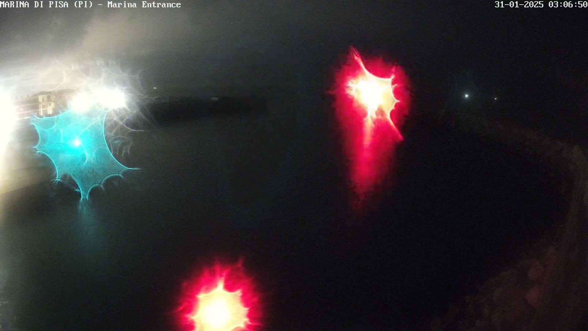 At night, blurry lights of various colors are reflected on dark water.