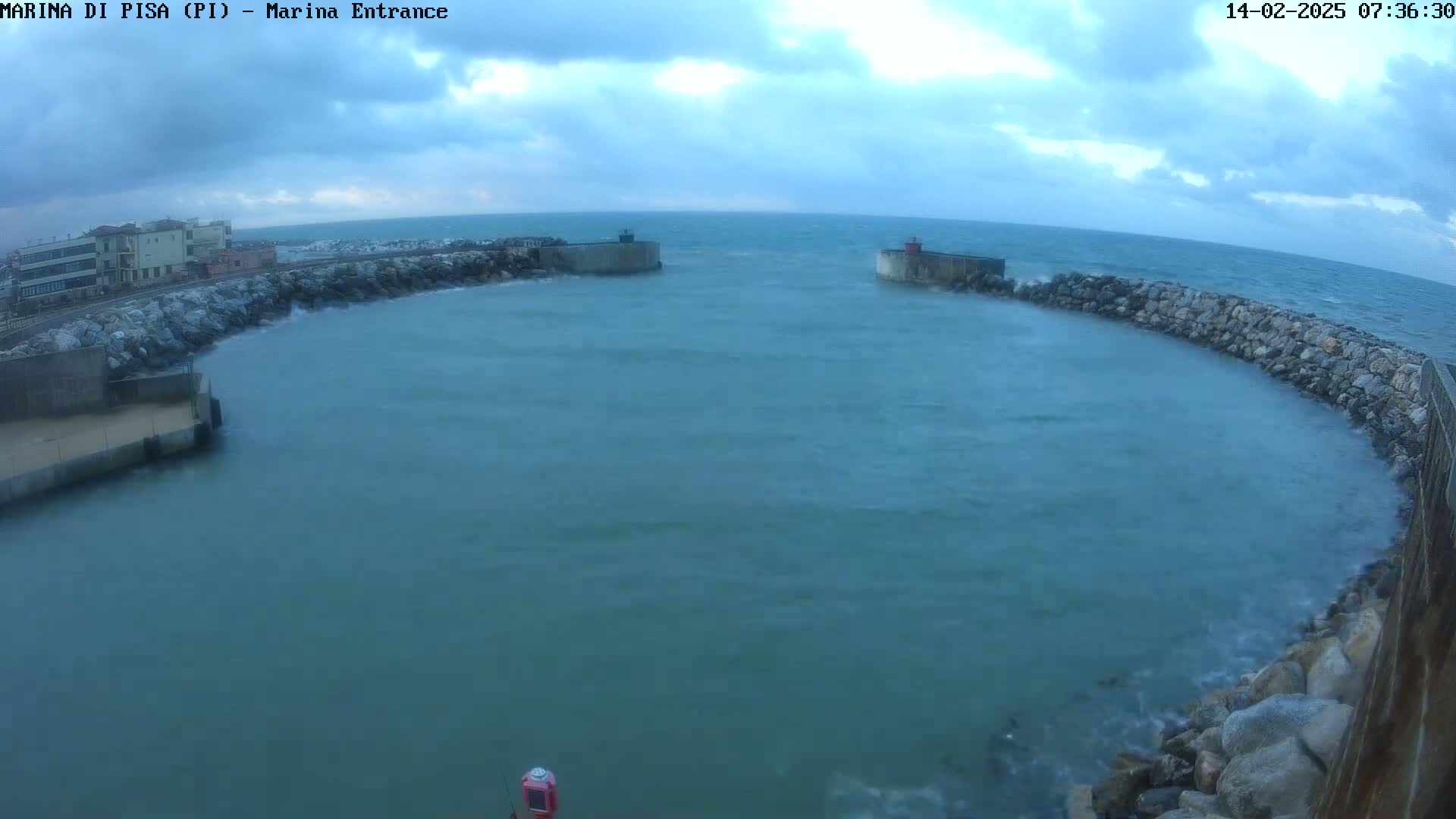A partially enclosed harbor with choppy water under a cloudy sky.