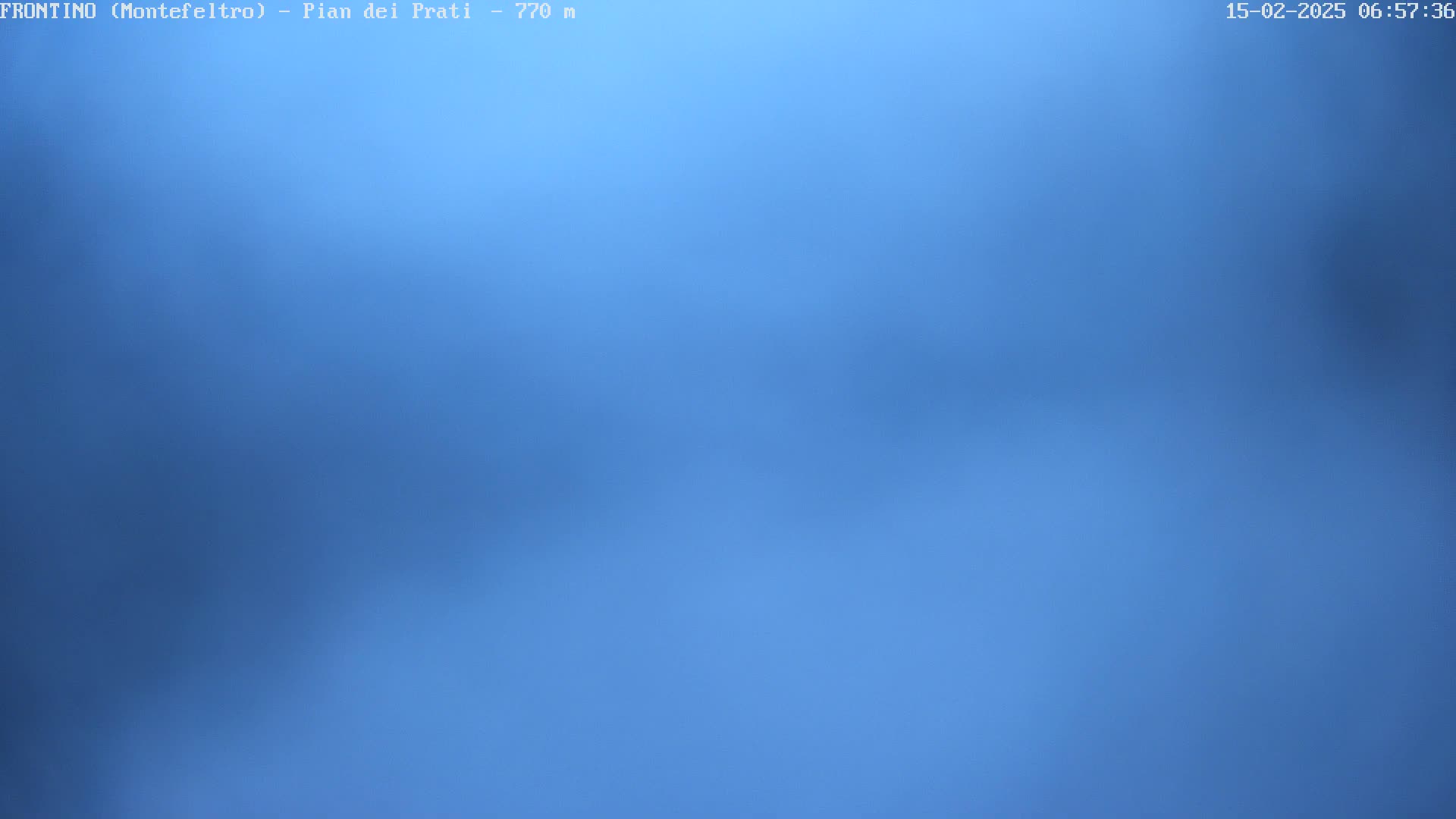 A mostly clear, light-blue sky is visible.