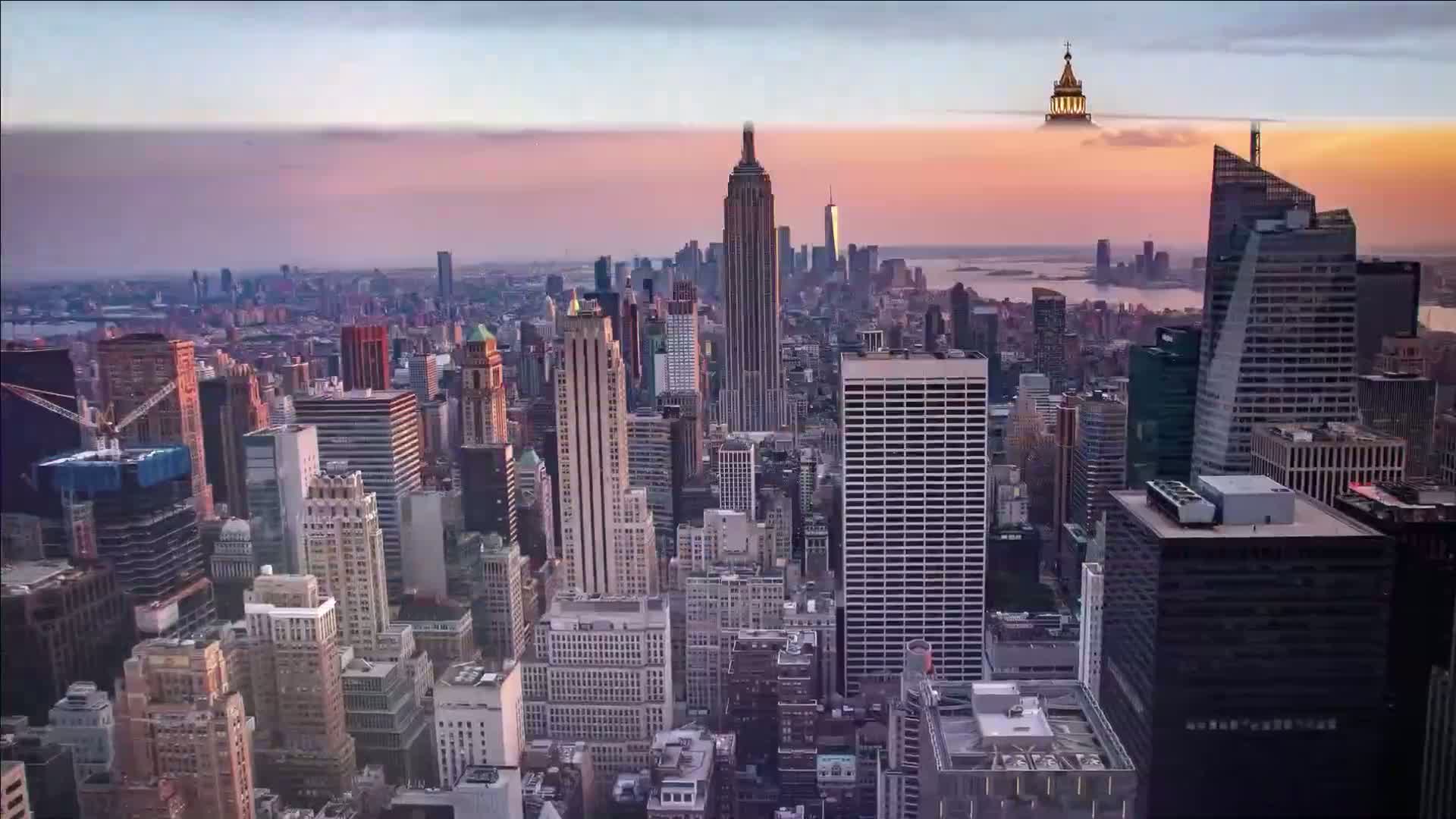 A sprawling cityscape at sunset, with numerous skyscrapers and buildings under a partly cloudy sky.