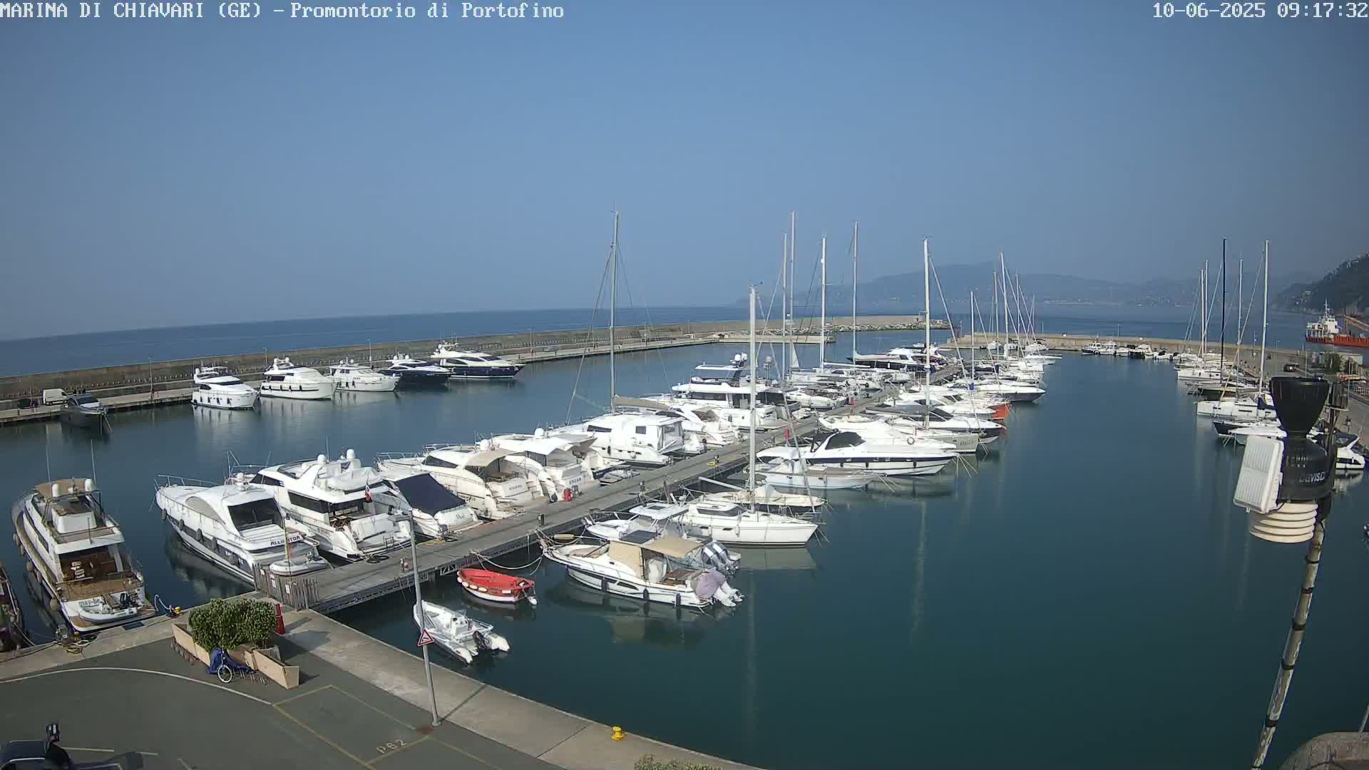 A marina filled with numerous yachts and sailboats on a sunny day.