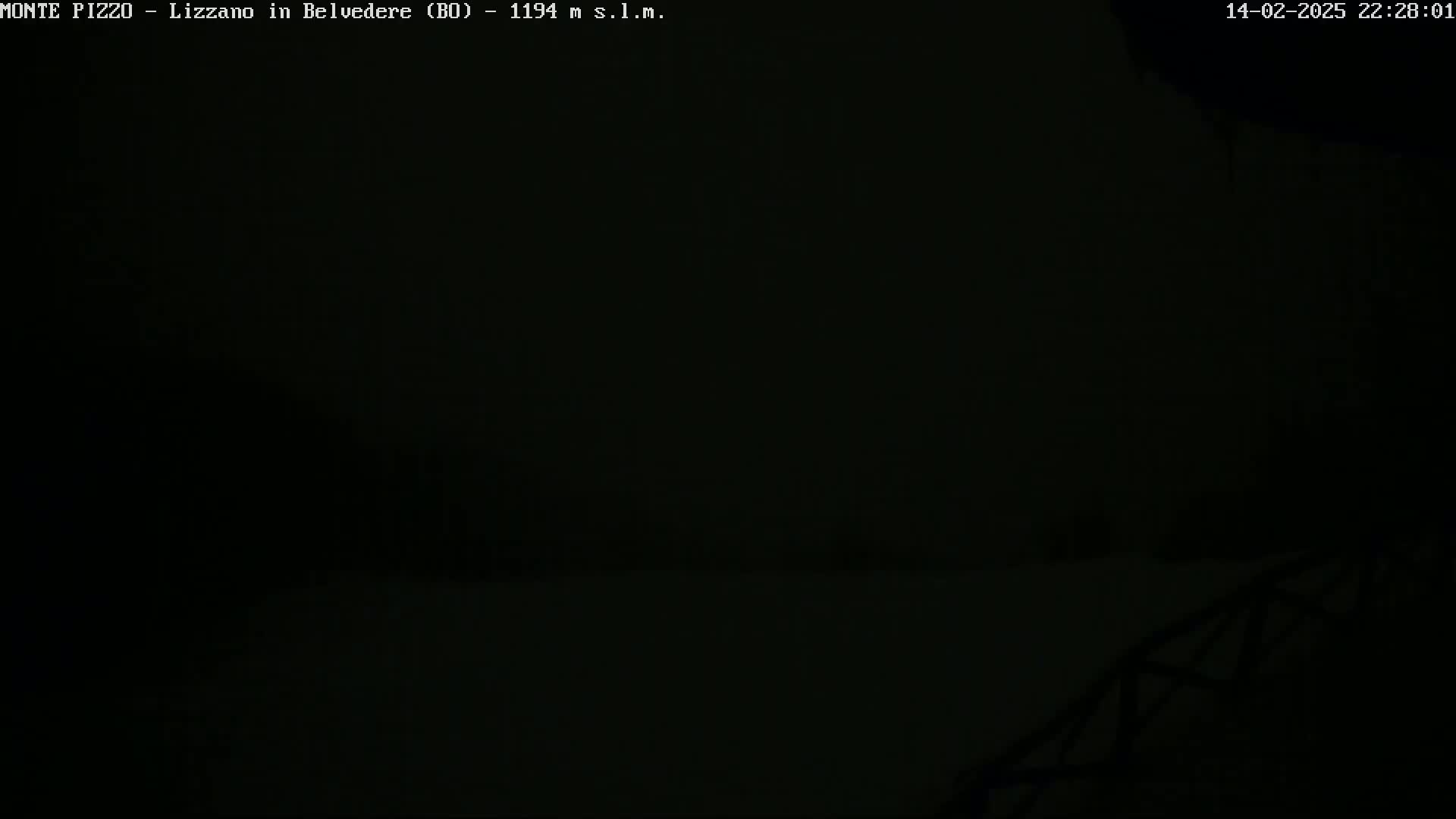 A dark, nighttime scene shows a mostly obscured landscape under a blanket of heavy fog or darkness.
