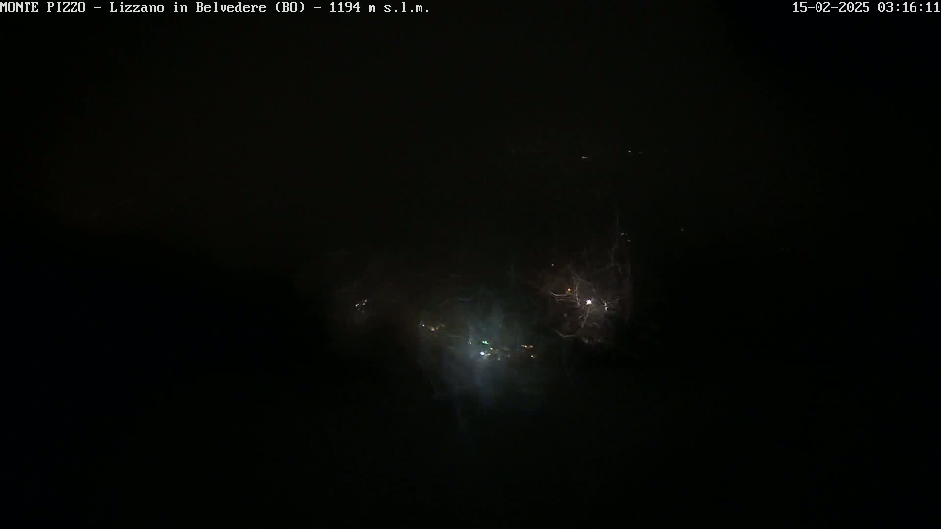 A nighttime image shows several bright lights and faint streaks of light against a dark sky.