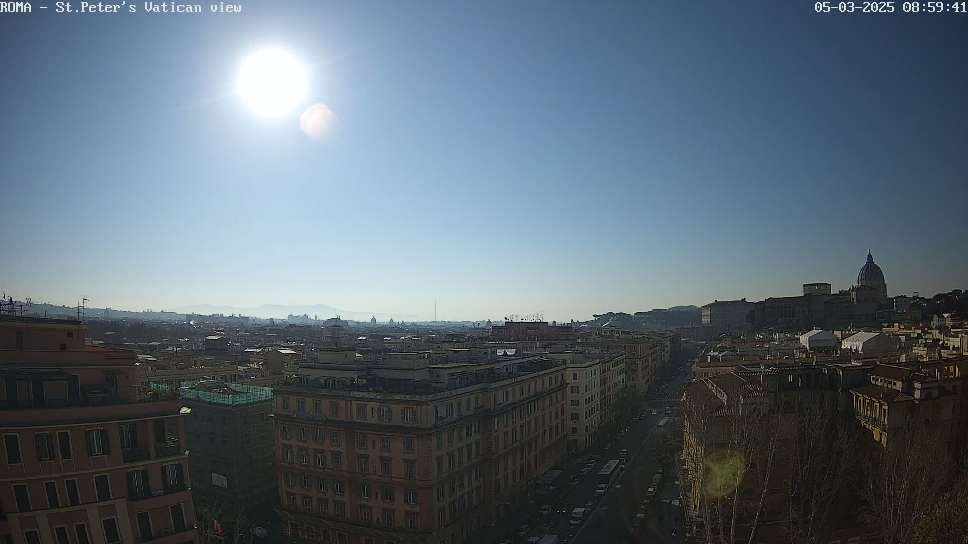 A sunny day reveals a cityscape with a large dome-topped building in the distance, viewed from a high vantage point.
