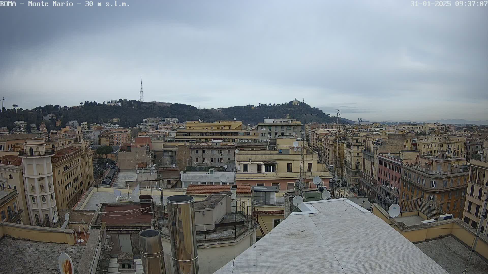 A city skyline with many buildings under an overcast sky.