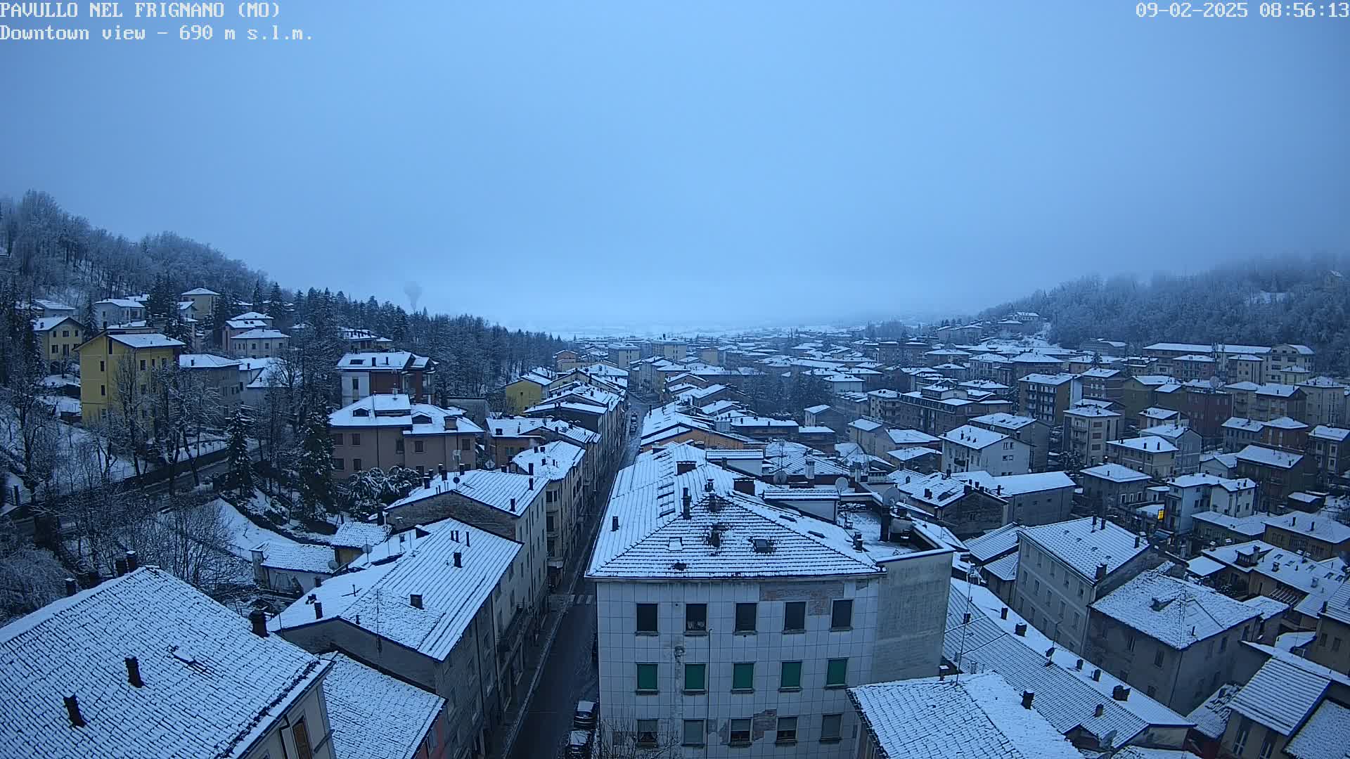 A snow-covered town is viewed from above on a cloudy day.