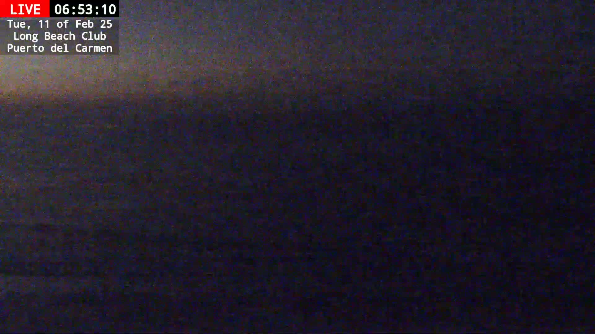 A dark, blurry image shows a dark body of water under a mostly dark sky, possibly at dawn or dusk.