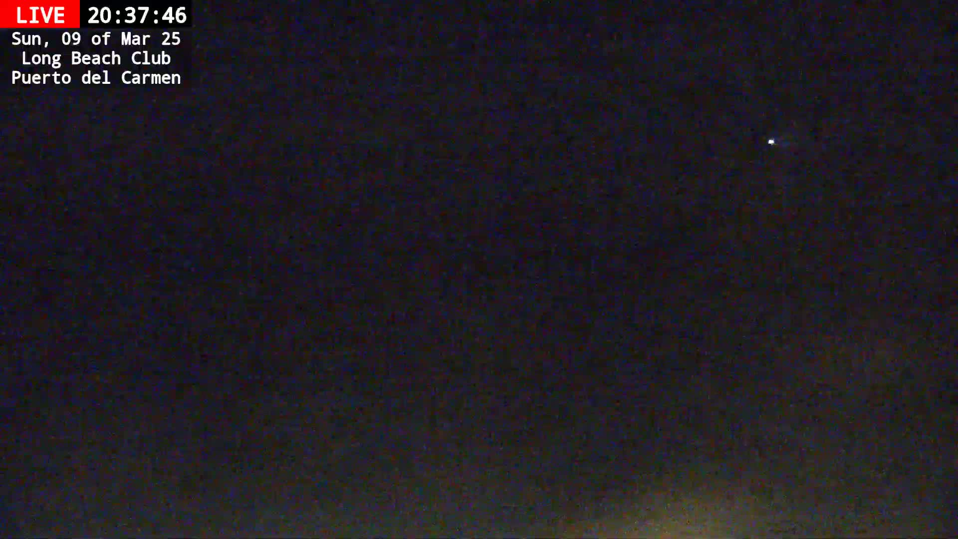 A dark night sky shows a single, faint light in the distance.