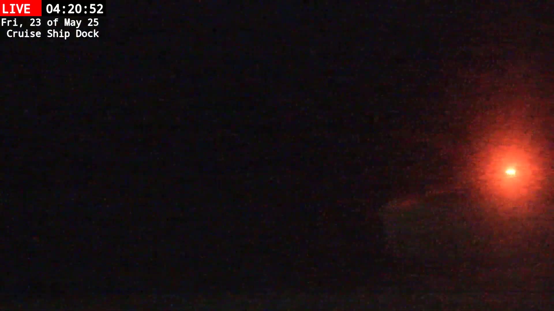 A bright red light is visible in the dark night sky.