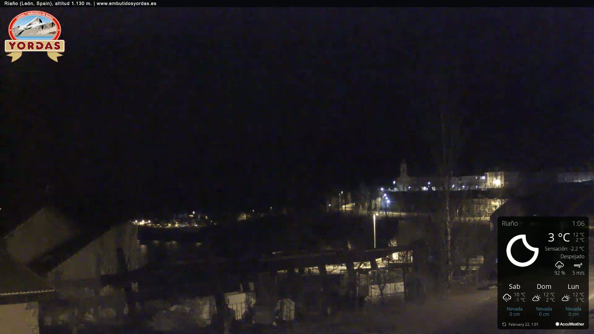 A nighttime, clear view of a small town illuminated by streetlights.