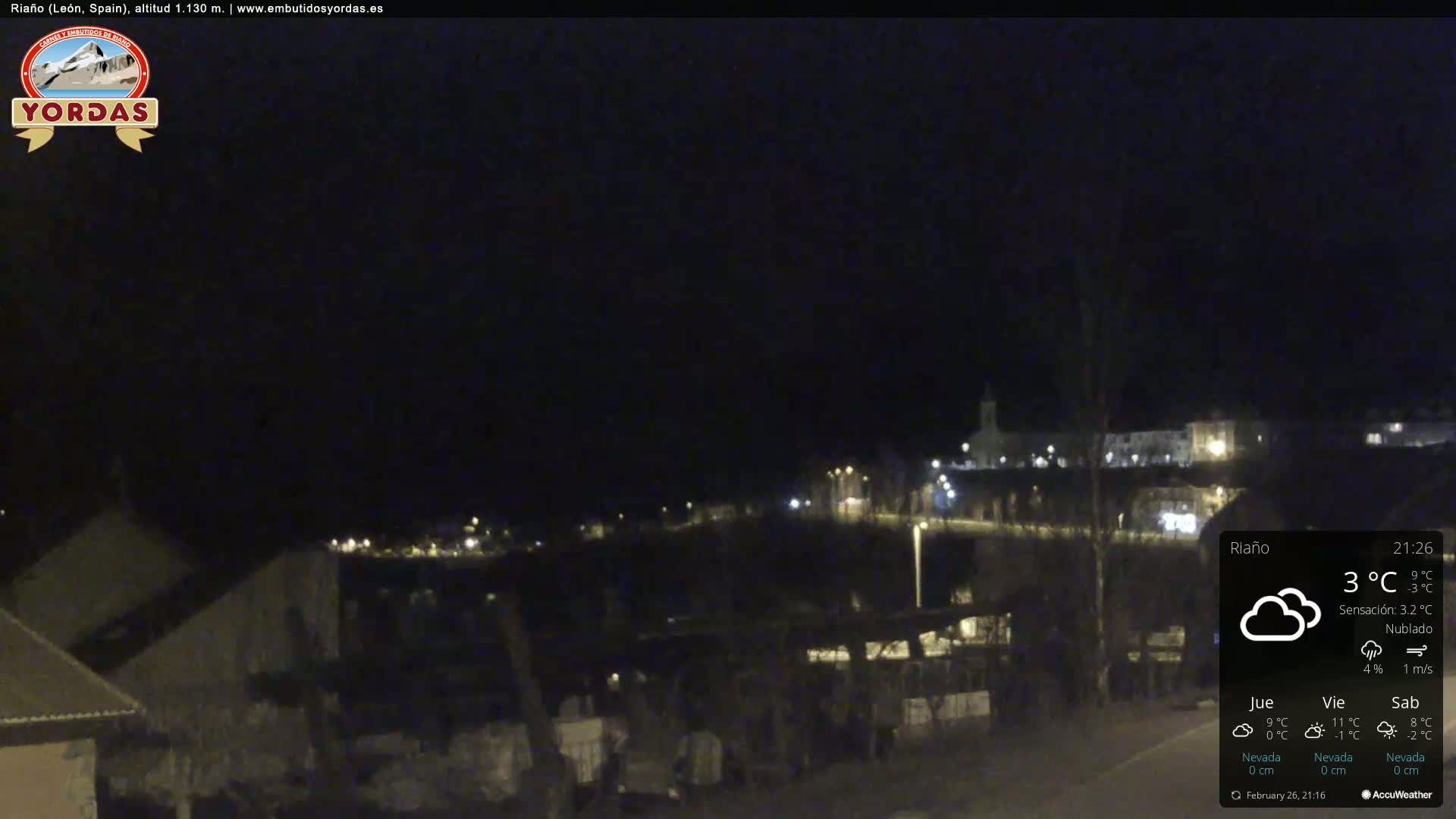 A nighttime view of a dimly lit town under cloudy skies, with a temperature of 3°C.
