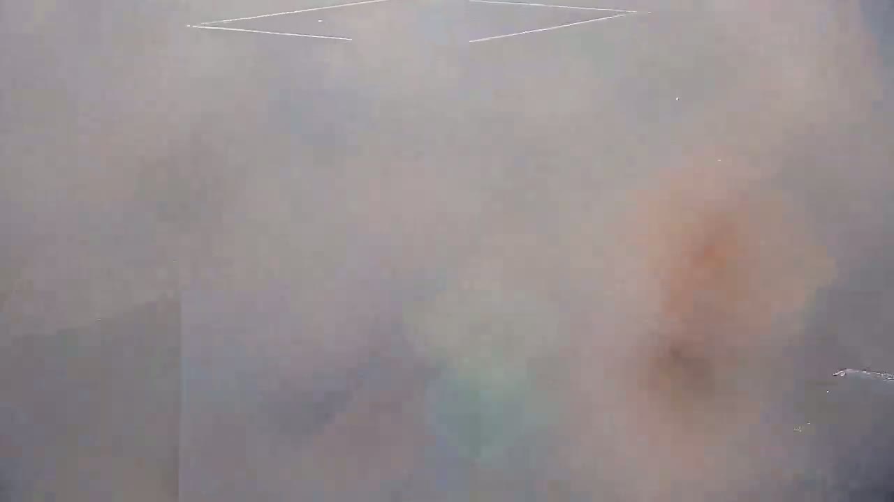 A hazy, blurry image shows indistinct shapes and colors, possibly suggesting smoke or fog.