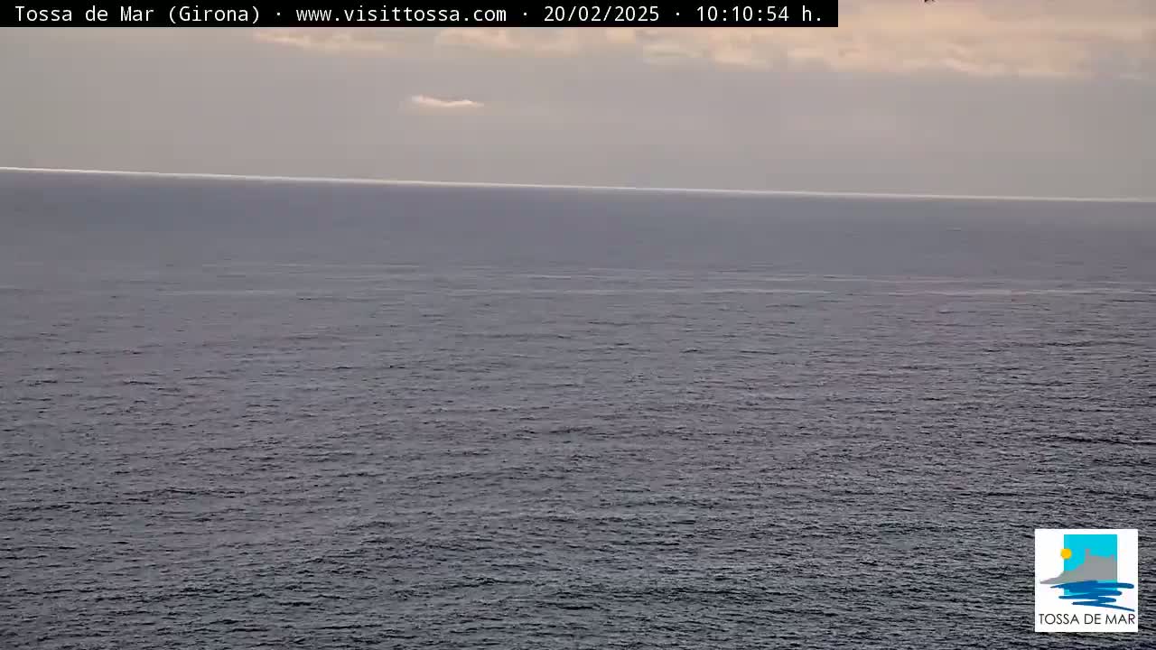 A calm, gray sea is visible under an overcast sky.