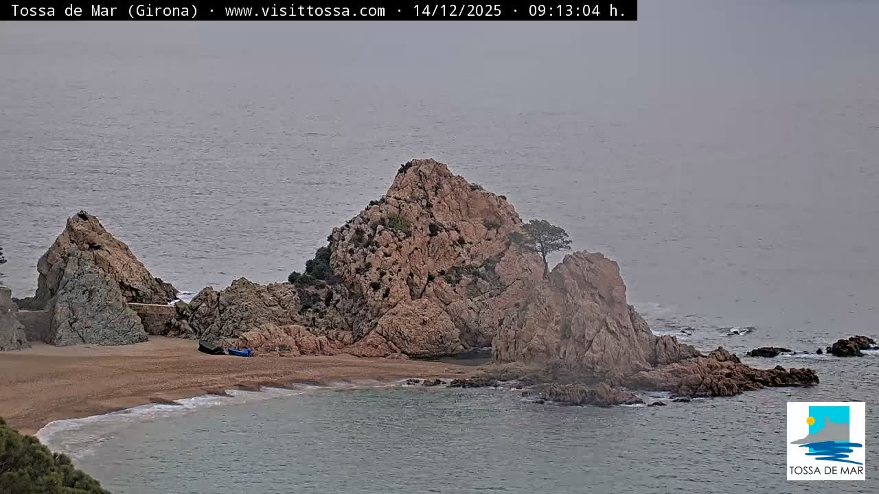 A small boat floats on calm ocean waters under a clear and bright sky, with intense morning sunlight shimmering across the surface.