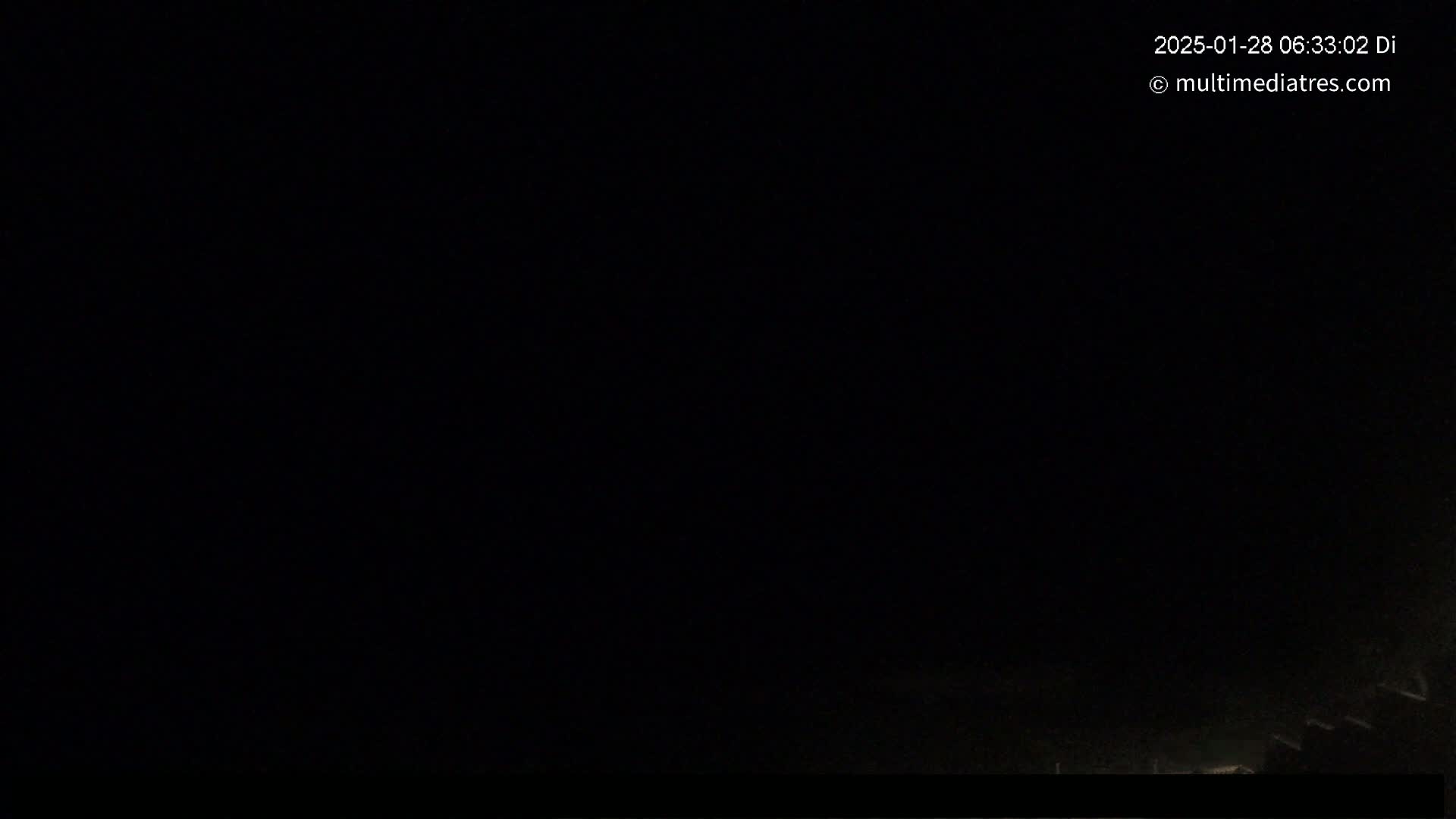The image is almost entirely black, suggesting nighttime conditions with very low visibility.