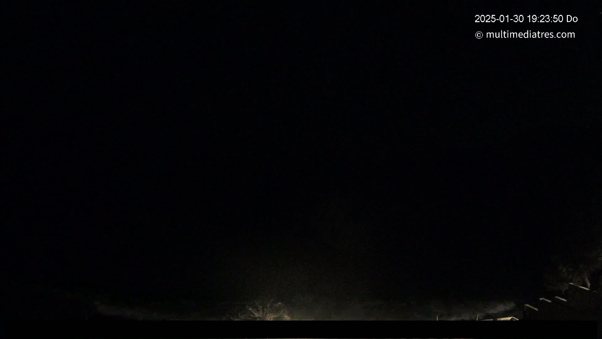 A nighttime scene shows a dark sky with faint light at the bottom, possibly from distant structures or lights.