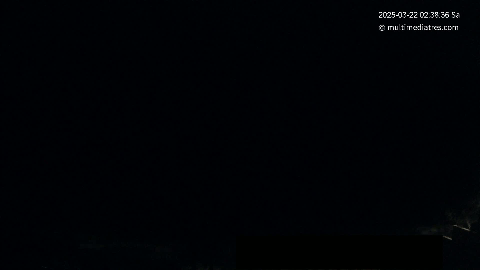 A mostly dark image shows a very faint, low light horizon line with a sliver of light at the bottom.