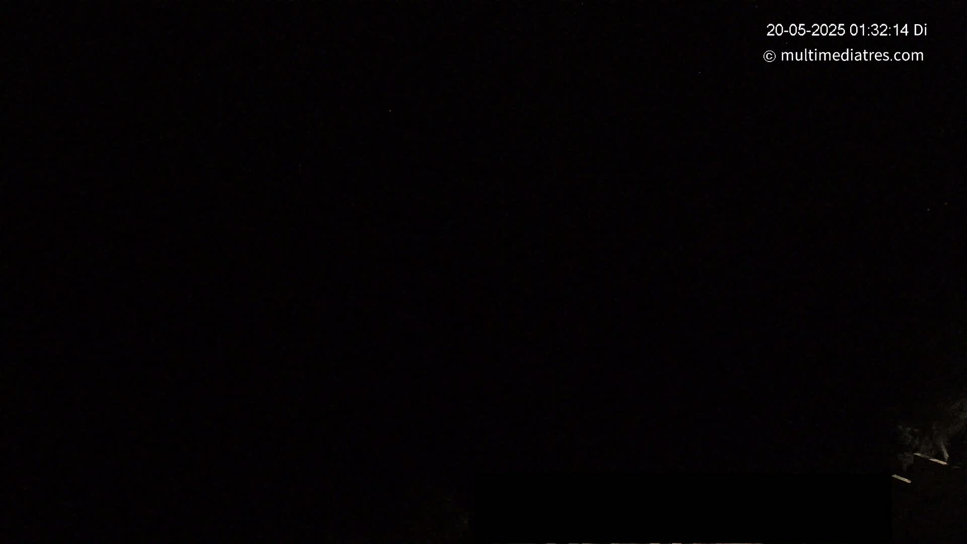 The image shows a nighttime scene with a dark sky and a small amount of faint light visible at the bottom edge.