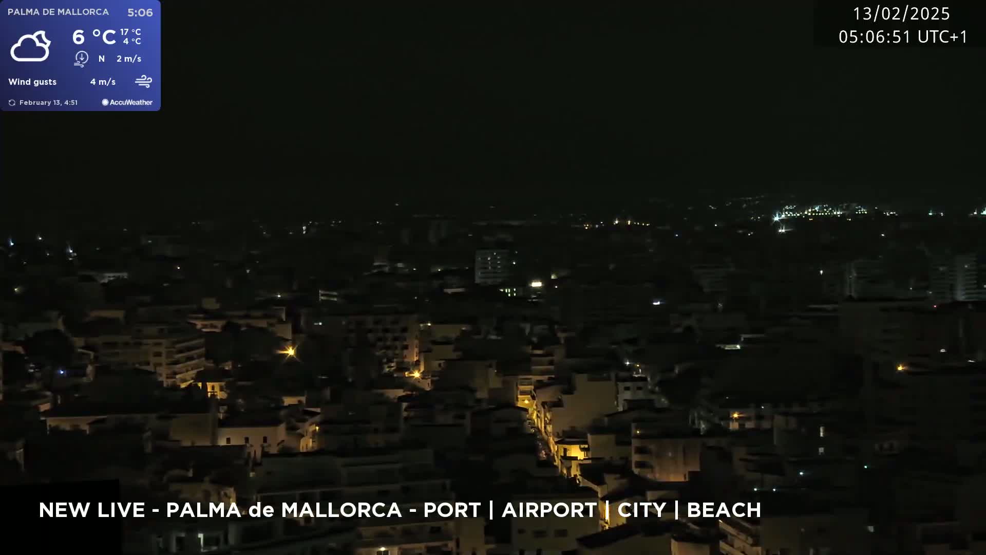 A nighttime, aerial view of a city with scattered lights under a mostly clear sky, a light north wind, and a temperature of 6°C.